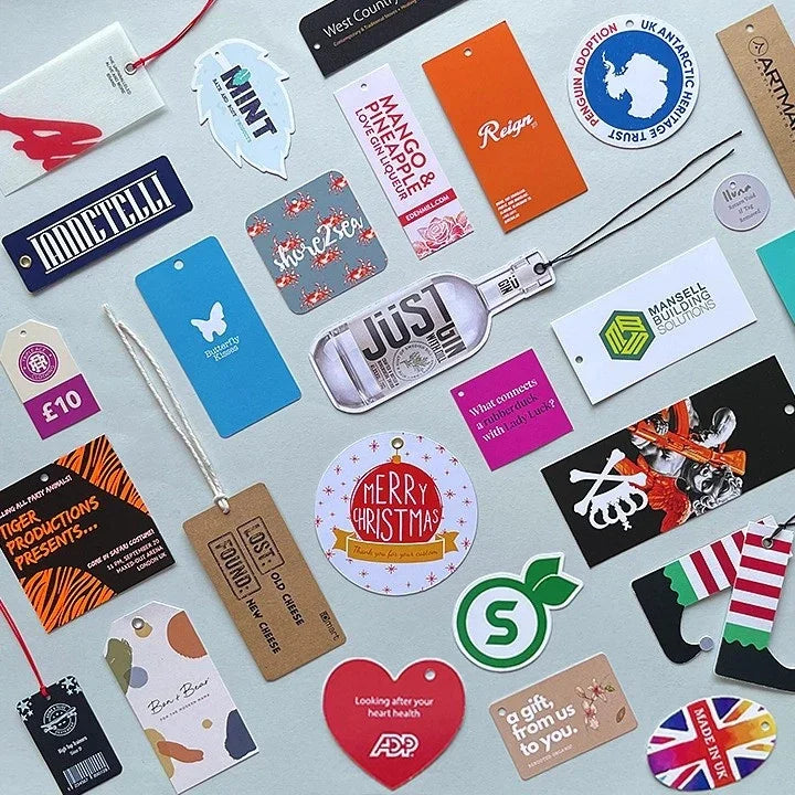 Assorted colourful personalised swing tags and labels for products including Christmas, drinks, health, and retail branding