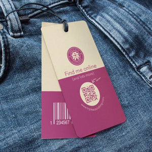 Clothing hang tags with QR code and barcode on blue denim jeans for online shopping and product info